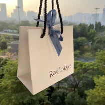 China Yadao custom design bag gift packaging shopping paper bag with rope handle and blue ribbon on the middle manufacturer