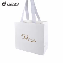 China custom fancy paper shopping bag packaging paper bag with ribbon handle manufacturer