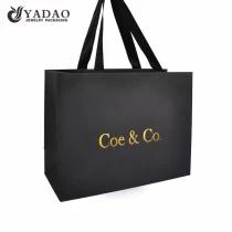 China fancy paper bag ribbon handle shopping paper bag texture finish paper packaging bag manufacturer