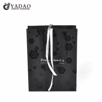China YADAO Luxury Holiday Bag Custom Logo Black Color CMYK New Design Cartoon Paper Bag for Clothes Gift Shopping manufacturer