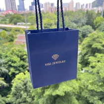 China Navy blue paper bag with own customize logo printed rope handle manufacturer