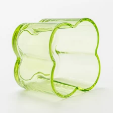 China Popular green color glass candle vessel with flower design manufacturer