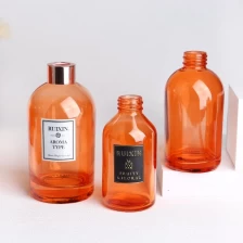 China Round Orange Diffuser Bottles with Labels, Caps, and  Screw Neck manufacturer