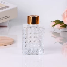 China 100ml 3.5oz geo cut square clear glass diffuser bottle with gold screw lid manufacturer