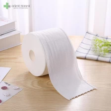 China Biodegradable 100%cotton fabric wet and dry use tissue roll for beauty salon manufacturer