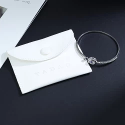 China Pu Leather Jewelry Bag with Stitching Ring Bangle Pendant Jewelry Pouch Debossed Logo manufacturer