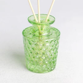 China transparent green electroplated laser fleck finished geo cut glass diffuser bottle manufacturer