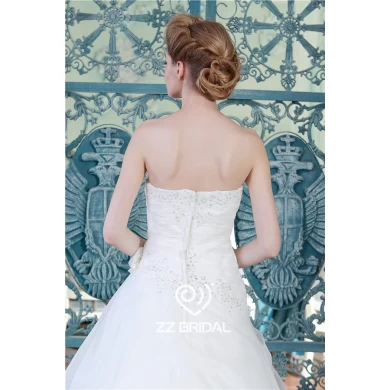 Private custom made beaded ruffled organza wedding dress with handmade flower