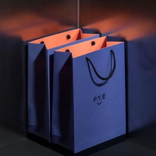 China Yadao wholesales design bag gift packaging shopping paper bag with rope handle and blue ribbon on the middle manufacturer