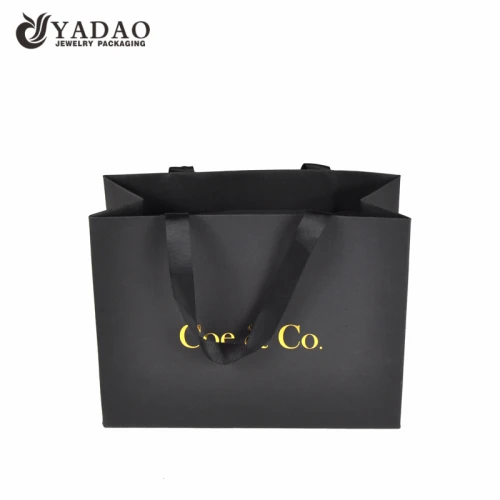 fantaisie sac en papier ruban poignée shopping sac en papier texture finition sac d'emballage en papier