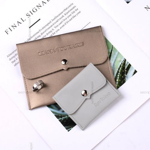 China customize jewelry packaging bag pu leather pouch bag snap design packaging jewelry with debossed logo on manufacturer