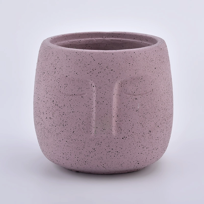 large concrete candle jars with face pattern