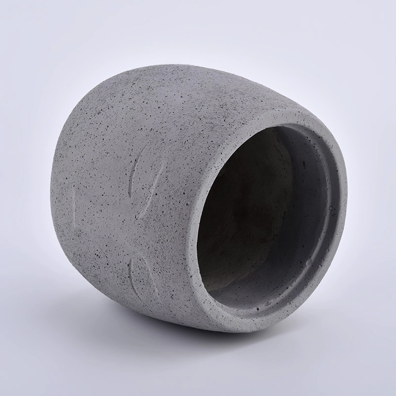 large concrete candle jars with face pattern
