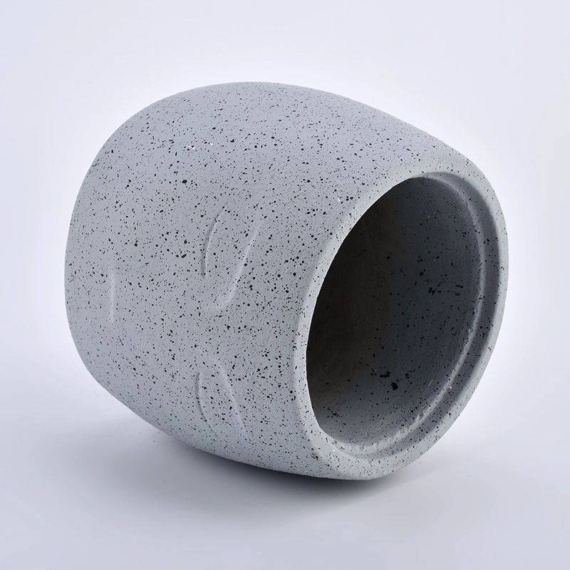 large concrete candle jars with face pattern