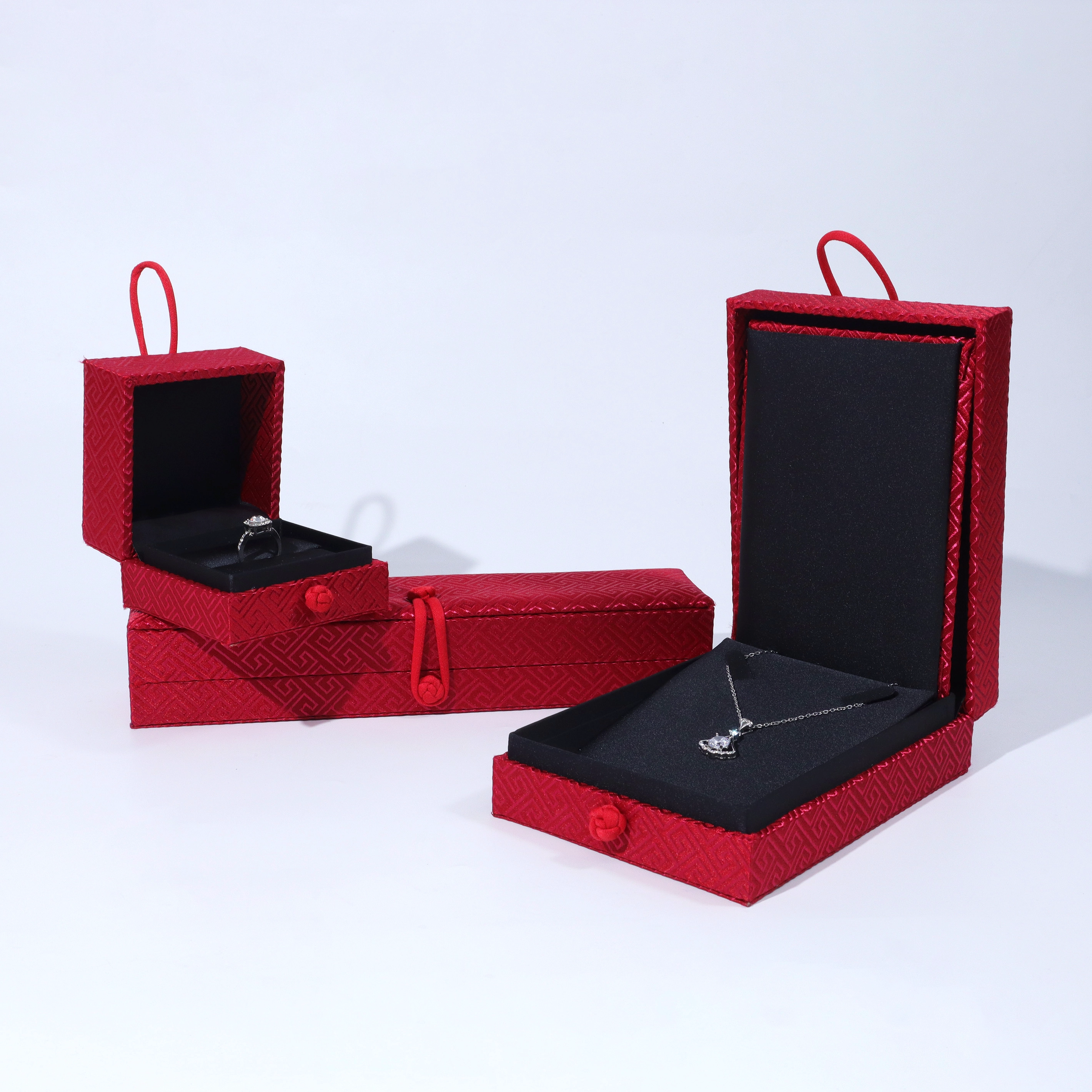 Klassisches Flip-Schmuckkästchen aus rotem Stoff in individueller Farbe. Glückliche festliche Zeremonie, goldenes Diamant-Schmuckkästchen-Set