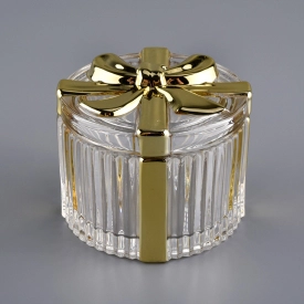 Bowknot progetta un contenitore per candele di vetro d’oro con coperchio