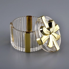 Bowknot progetta un contenitore per candele di vetro d’oro con coperchio