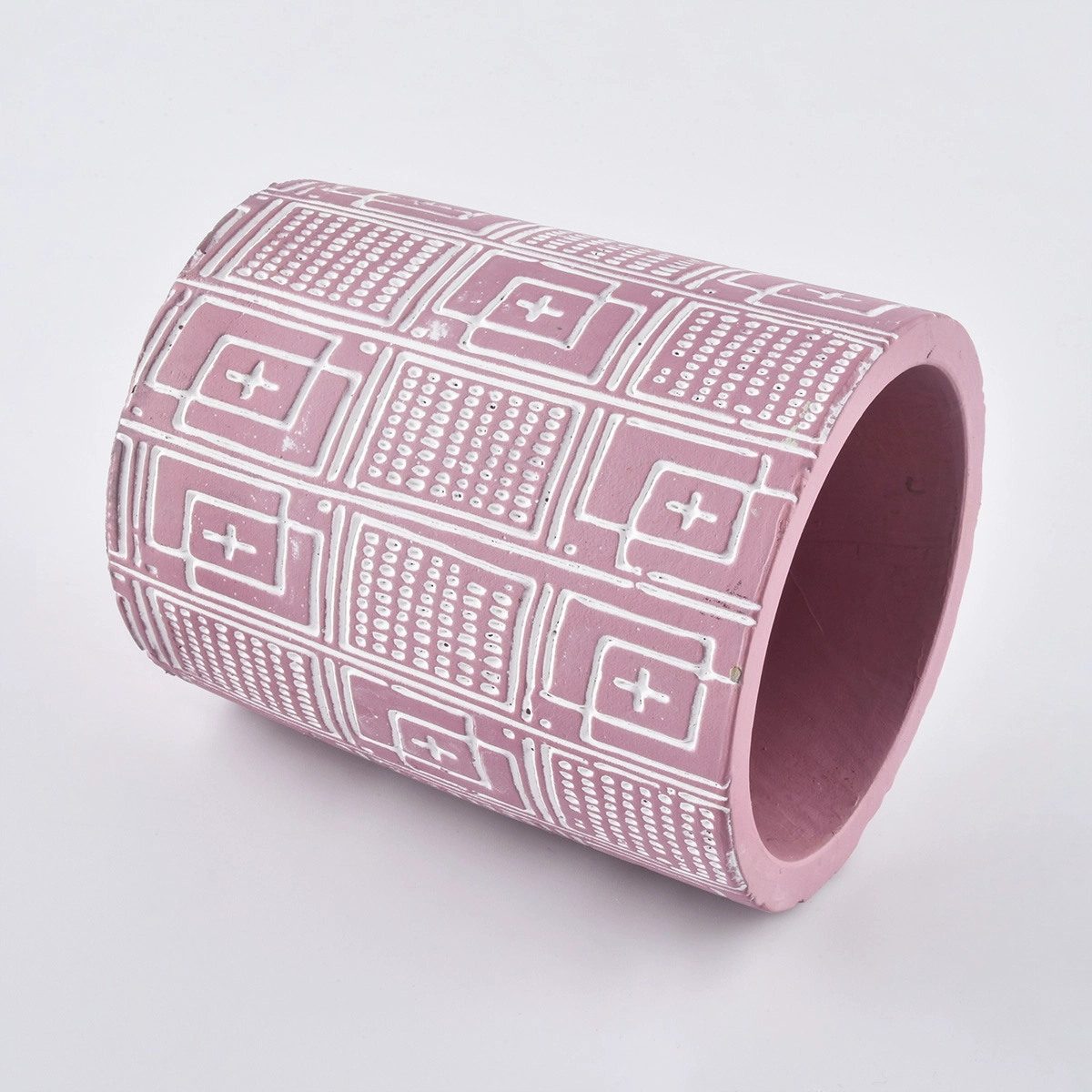 pink candle jar with white dcement ebossed pattern  