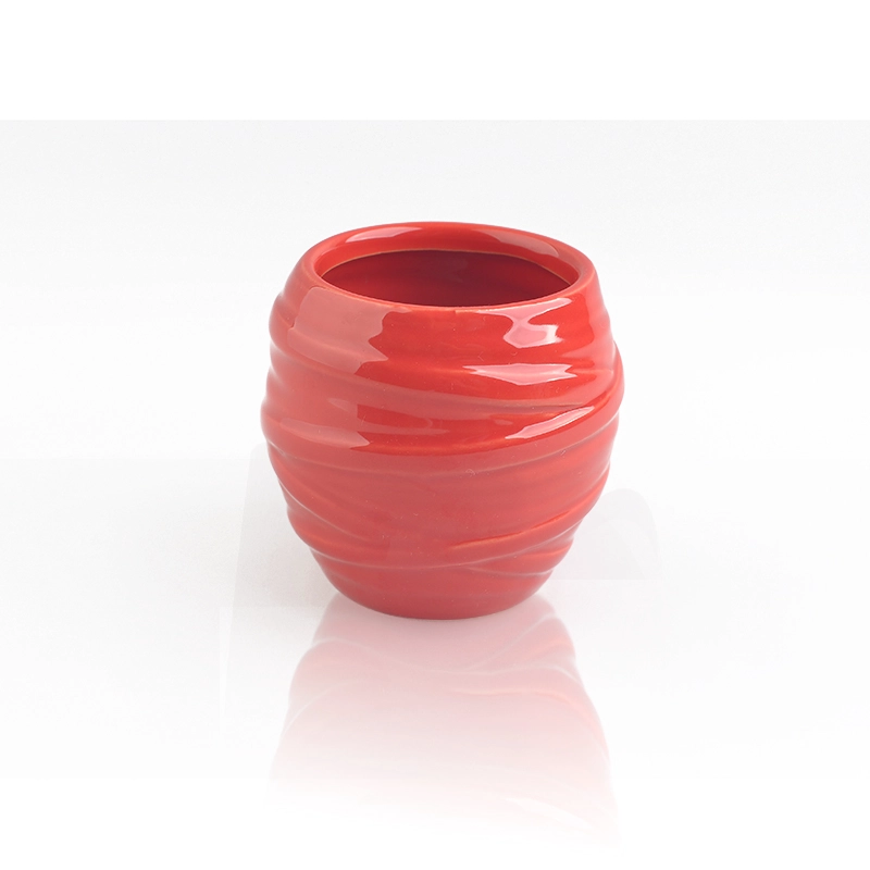 red glazing candle holders with spiral pattern