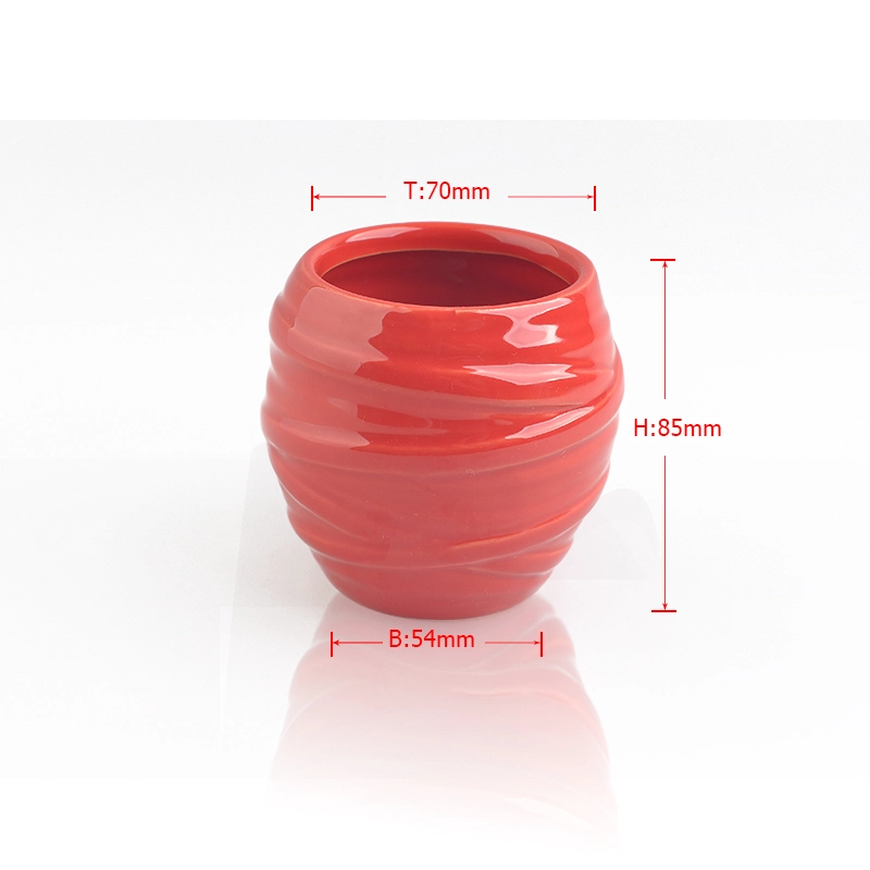 red glazing candle holders with spiral pattern