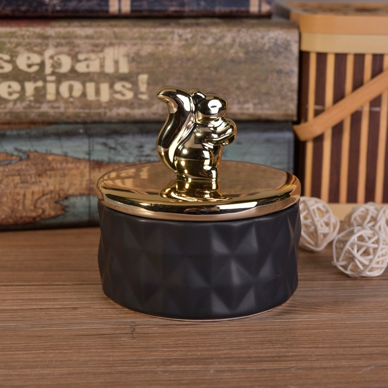Matte black ceramic containers with gold animal lids