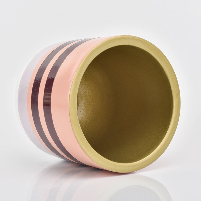 pink line decorated concrete candle container with golden inside
