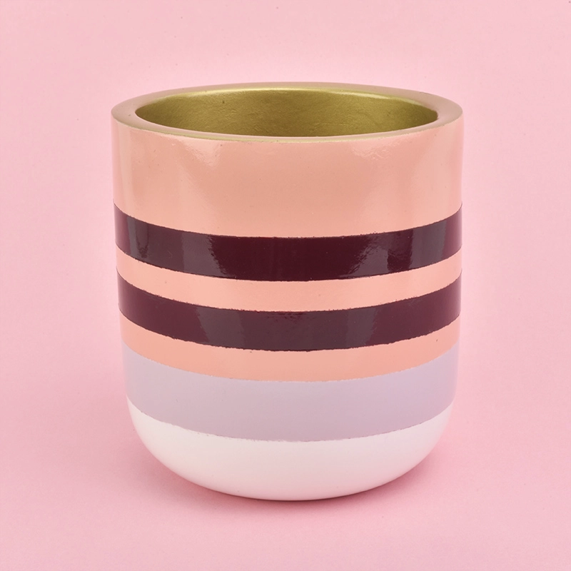 pink line decorated concrete candle container with golden inside