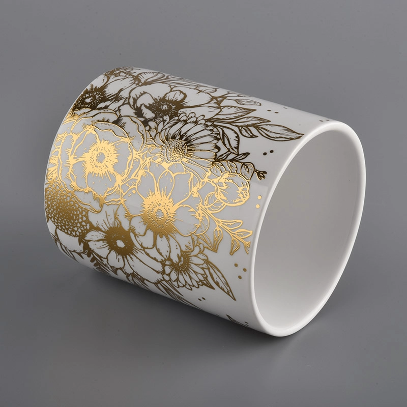 white ceramic candle jars with gold printing