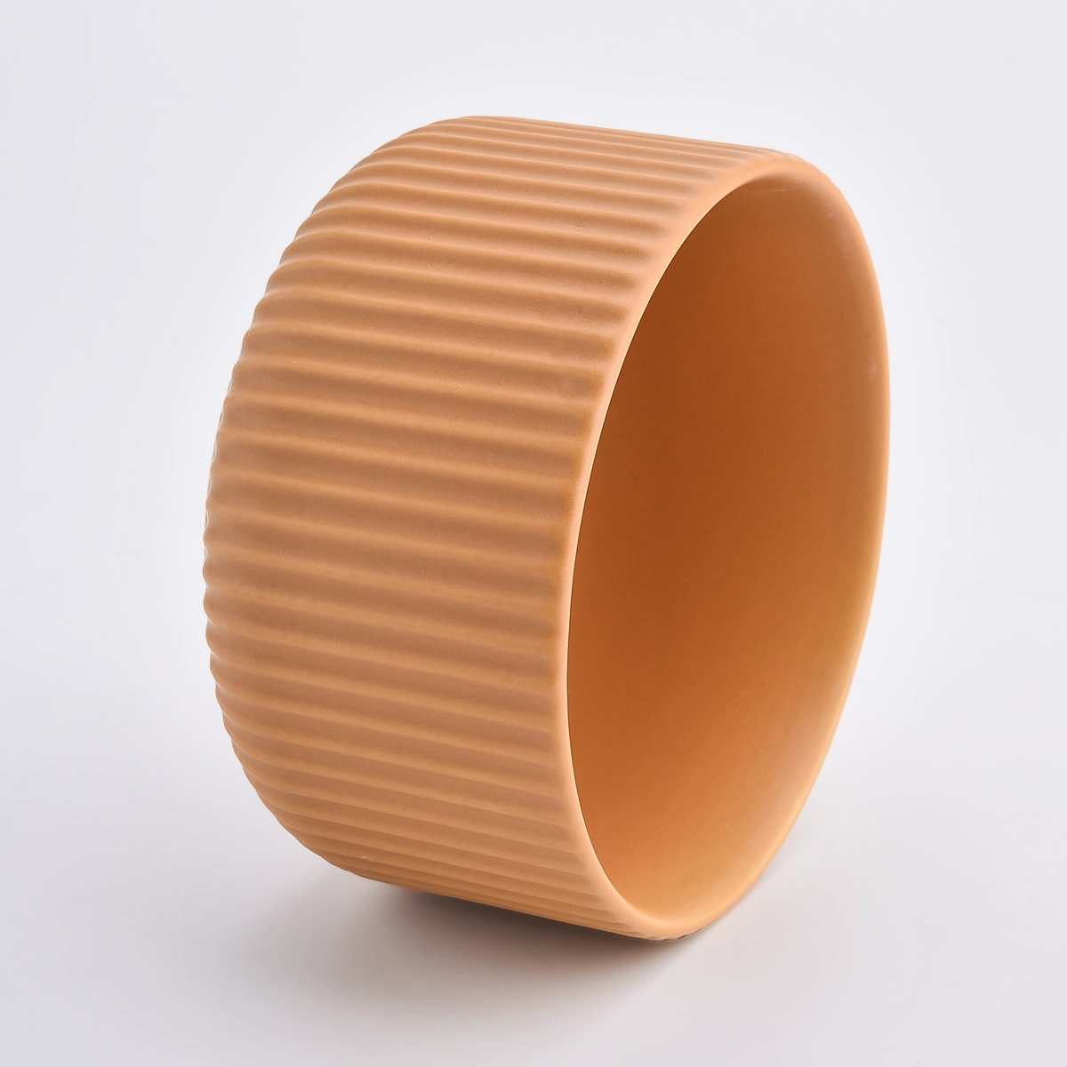 peach glazed ceramic candle vessels with stripe designs
