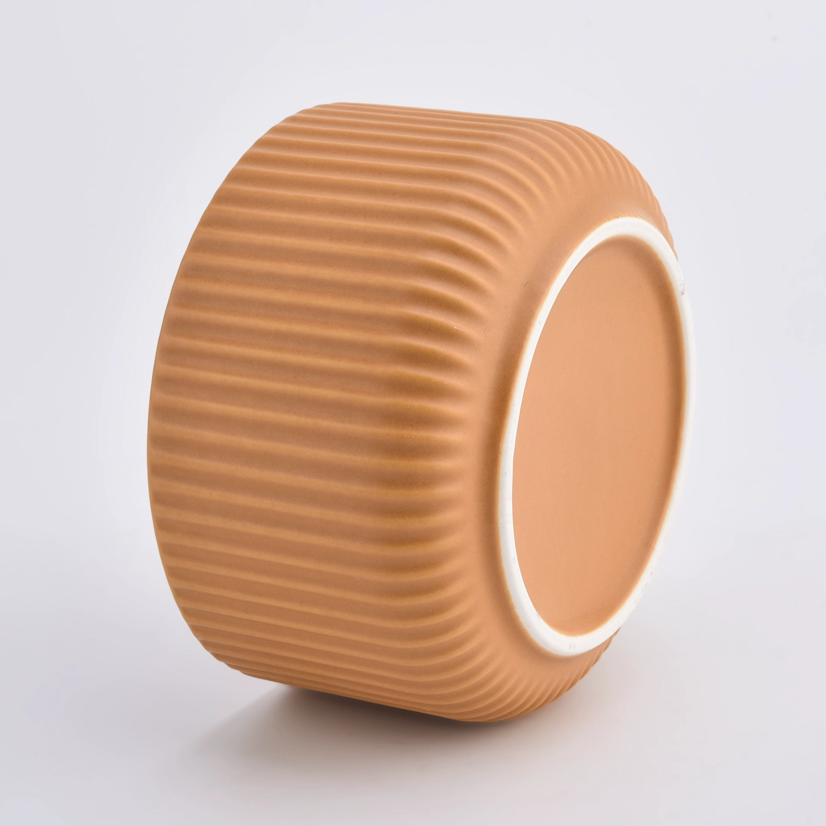 peach glazed ceramic candle vessels with stripe designs