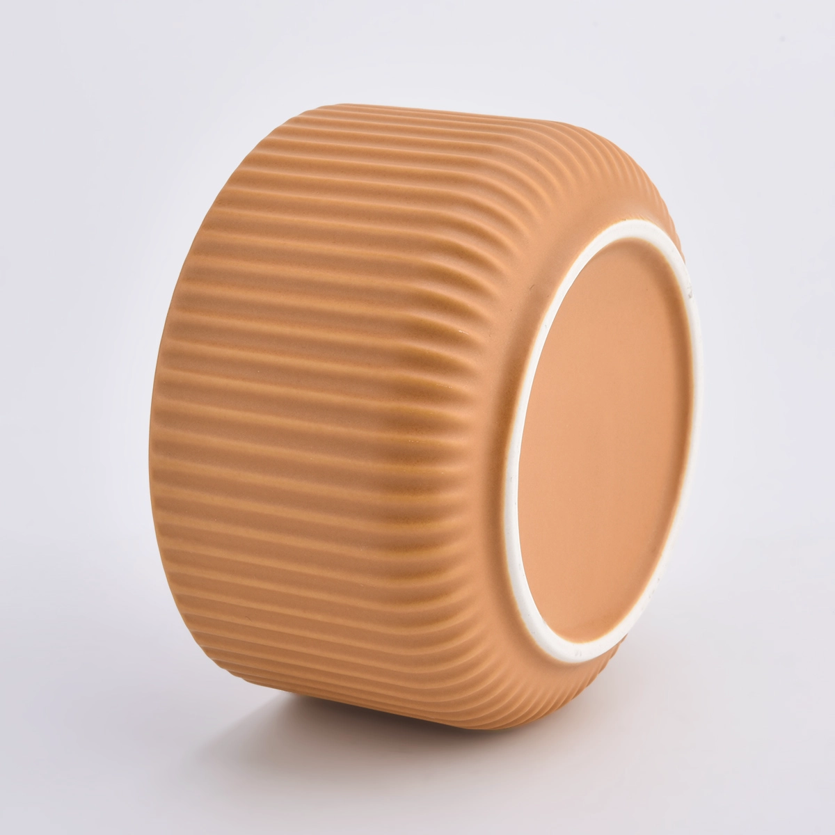peach glazed ceramic candle vessels with stripe designs