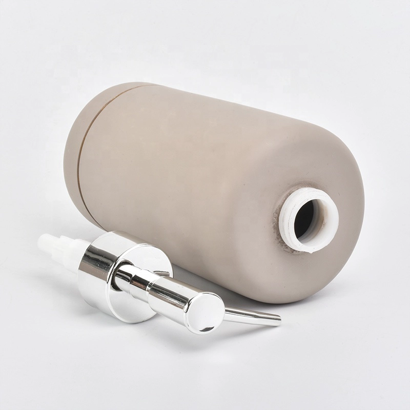 grey concrete bath room accessories with lotion bottles dispenser toothbrush holder