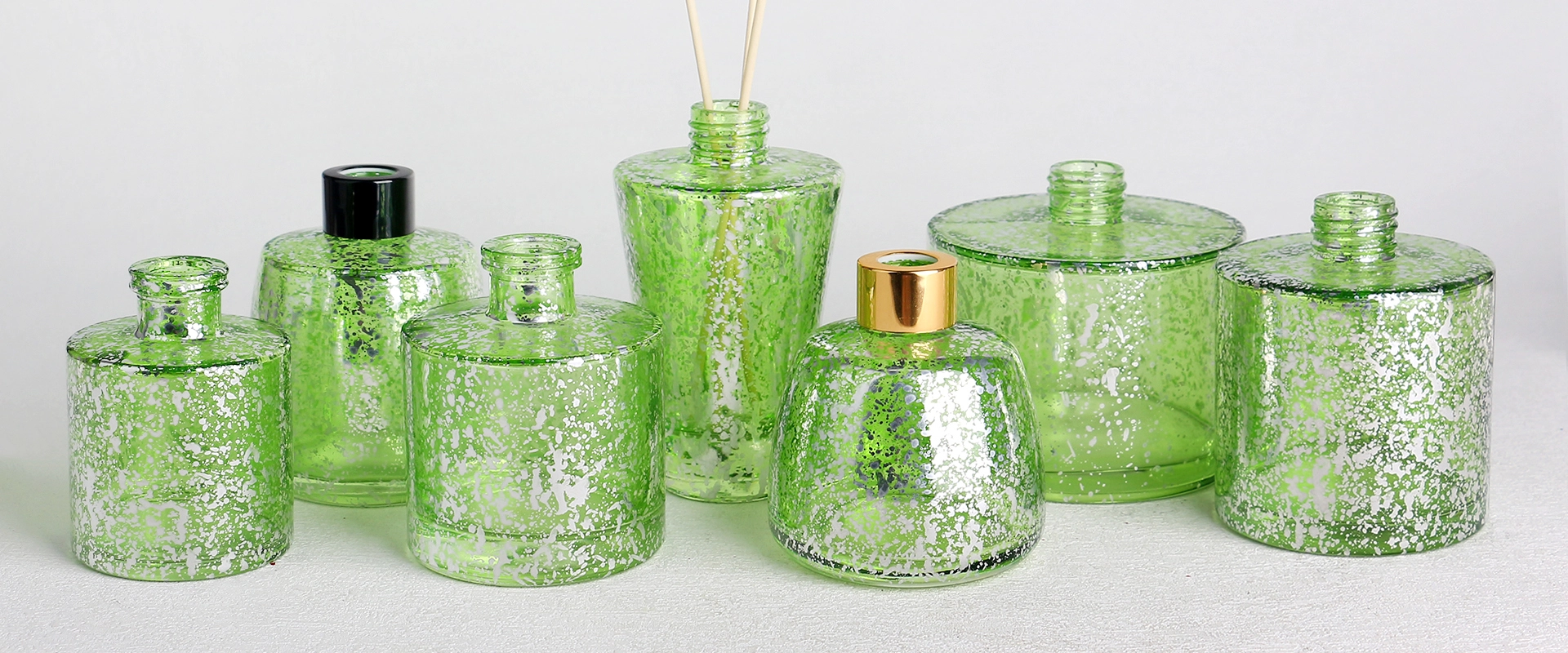 Electroplated laser glass diffuser bottles banner