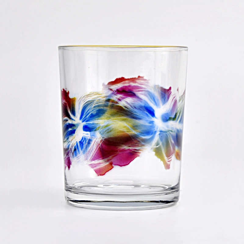 clear glass candle jar with colorful painting and gold ring