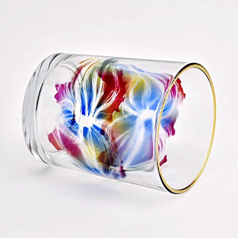 clear glass candle jar with colorful painting and gold ring