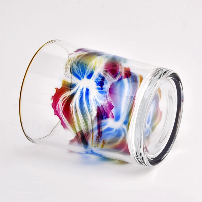 clear glass candle jar with colorful painting and gold ring