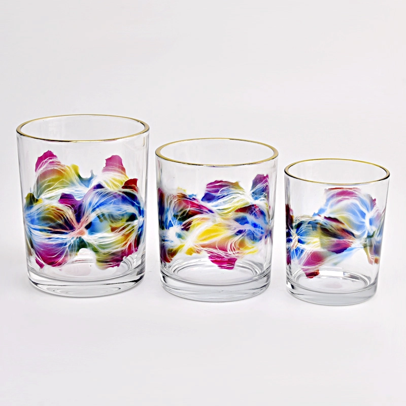 clear glass candle jar with colorful painting and gold ring