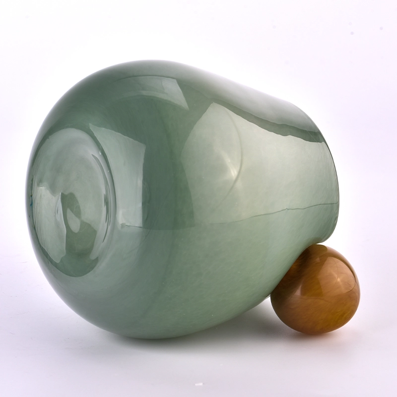 Mouth blown glass candle jars with round handle 
