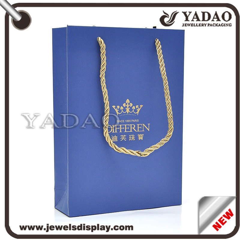 China Custom MOQ 1000 High quality blue paper packing bags with gold hot stamping logo and gold fiber cord for shop store and shopping bags gift hand bags manufacturer