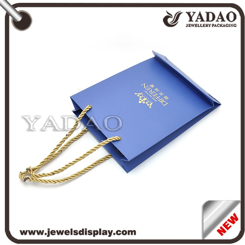 China Custom MOQ 1000 High quality blue paper packing bags with gold hot stamping logo and gold fiber cord for shop store and shopping bags gift hand bags manufacturer