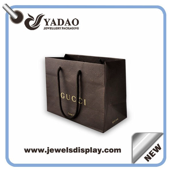 China Custom size and color line paper packaging bag with handles and logo printed manufacturer