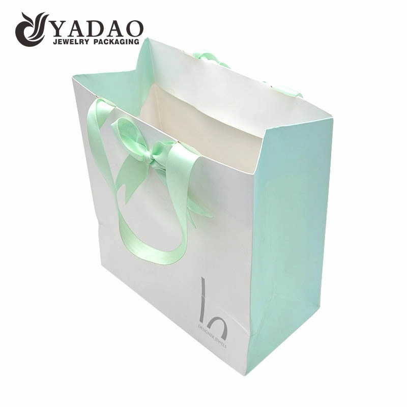 China Yadao printing paper bag jewelry packaging bag shopping bag gift bag in three colors printing with ribbon handle and closure manufacturer