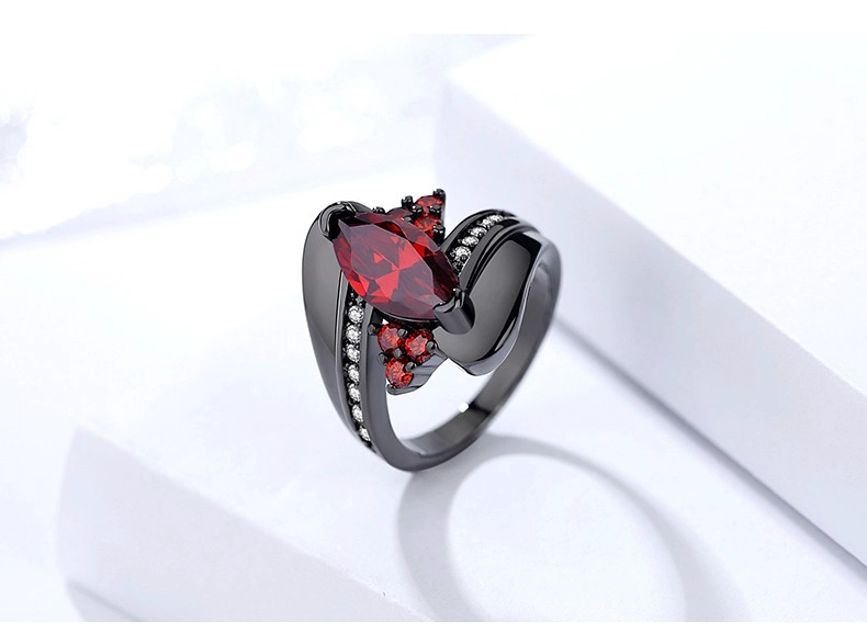 China Custom unique wave design black gold ruby gemstone finger ring for women fabricante